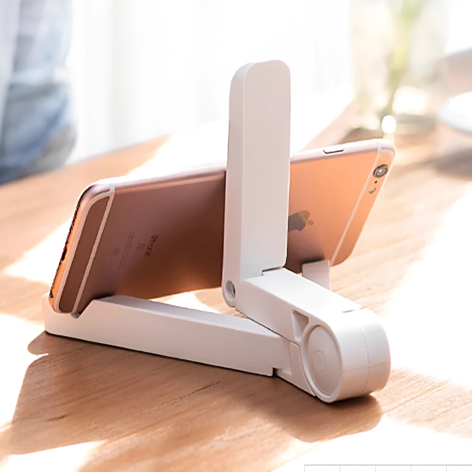 Black foldable aluminium tablet holder shown open and folded flat next to a smartphone