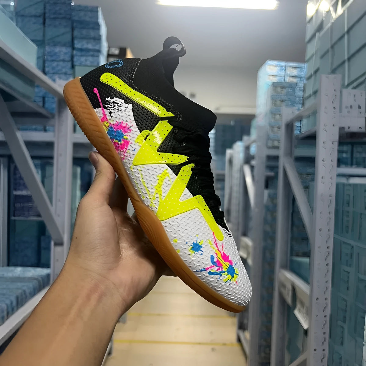 Low-top football boots with replaceable spikes in Black & Yellow colourway.