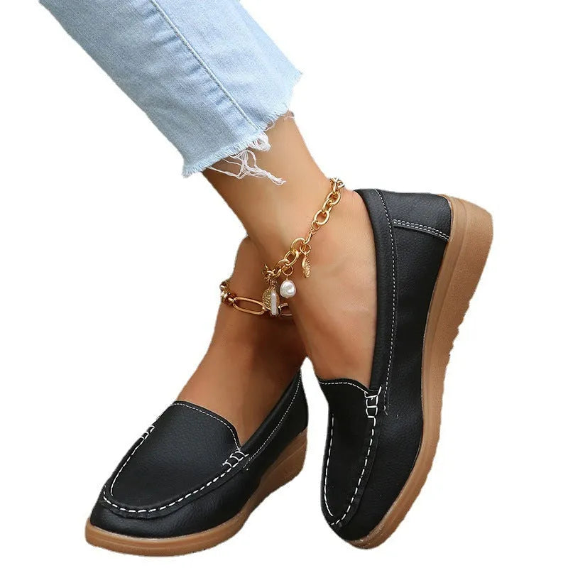 Women's PU leather flat loafers in multiple colours with round toe and car suture detail.