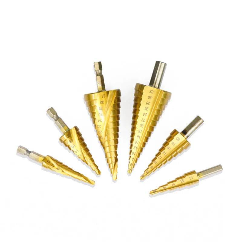 Cone-shaped step drill bits and a centre punch from a high-speed steel tool set on a workshop bench.