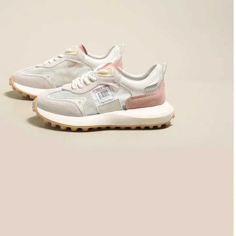 Women's grey and pink retro low-top sneaker with round toe and rubber sole.