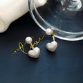 Korean style heart-shaped pearl stud earrings for women with artificial gem inlays on electroplated alloy.