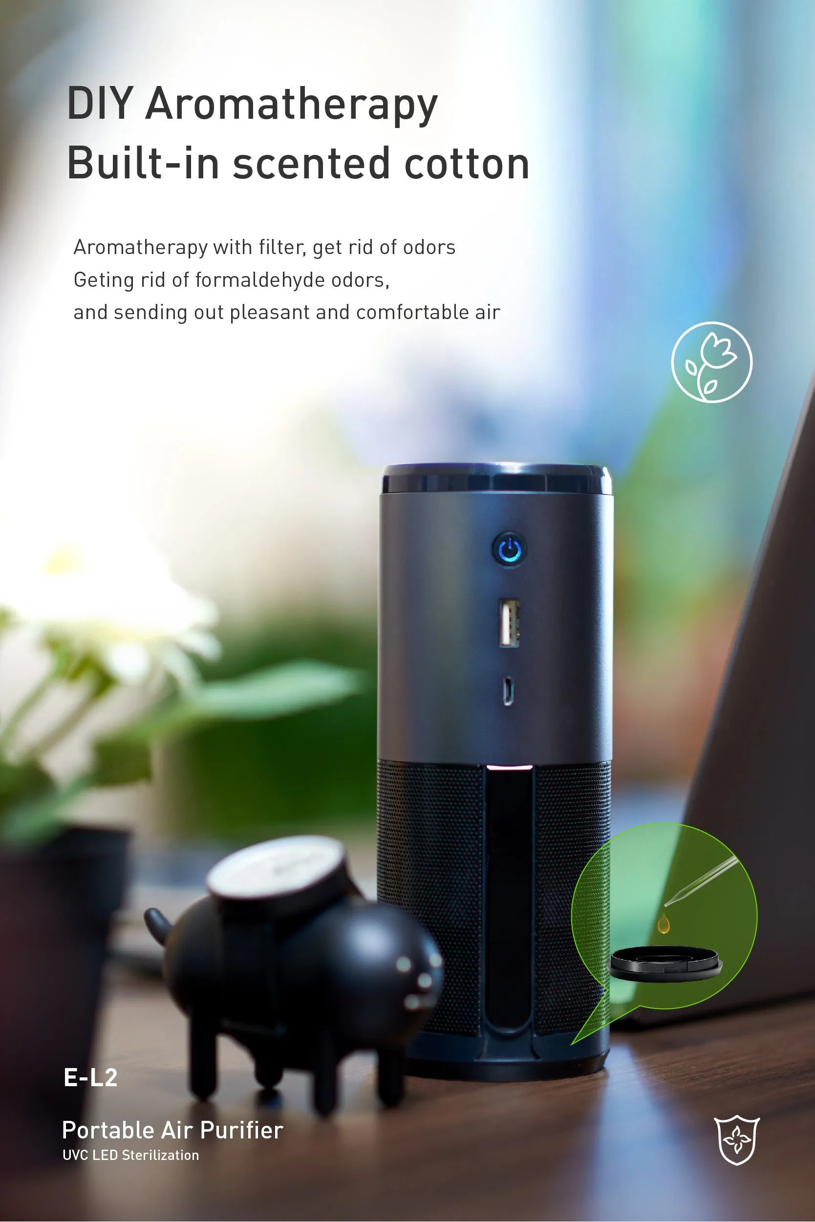 Black portable mini car air purifier with USB cable next to a car cup holder.