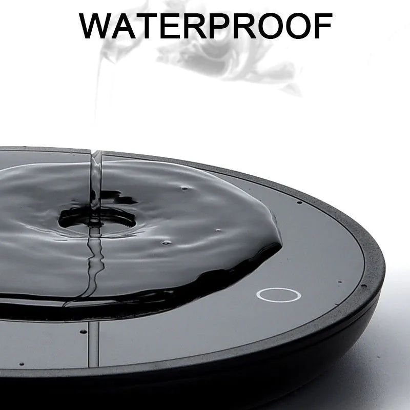 Black circular coffee cup warmer with low and high temperature switch on a desk