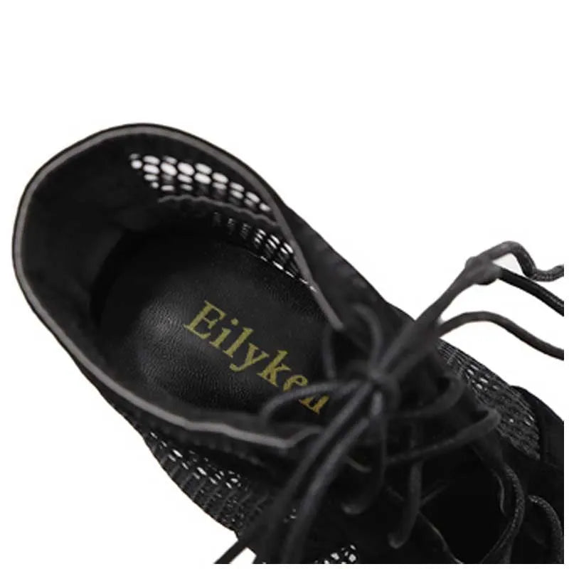 Black suede women's lace-up high heel shoes with an 11.5 cm heel on a plain background.