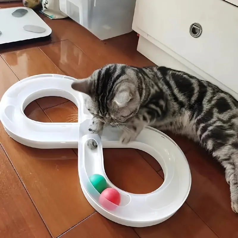 Blue and white cat turntable track ball toy with teasing stick attachment on flat surface