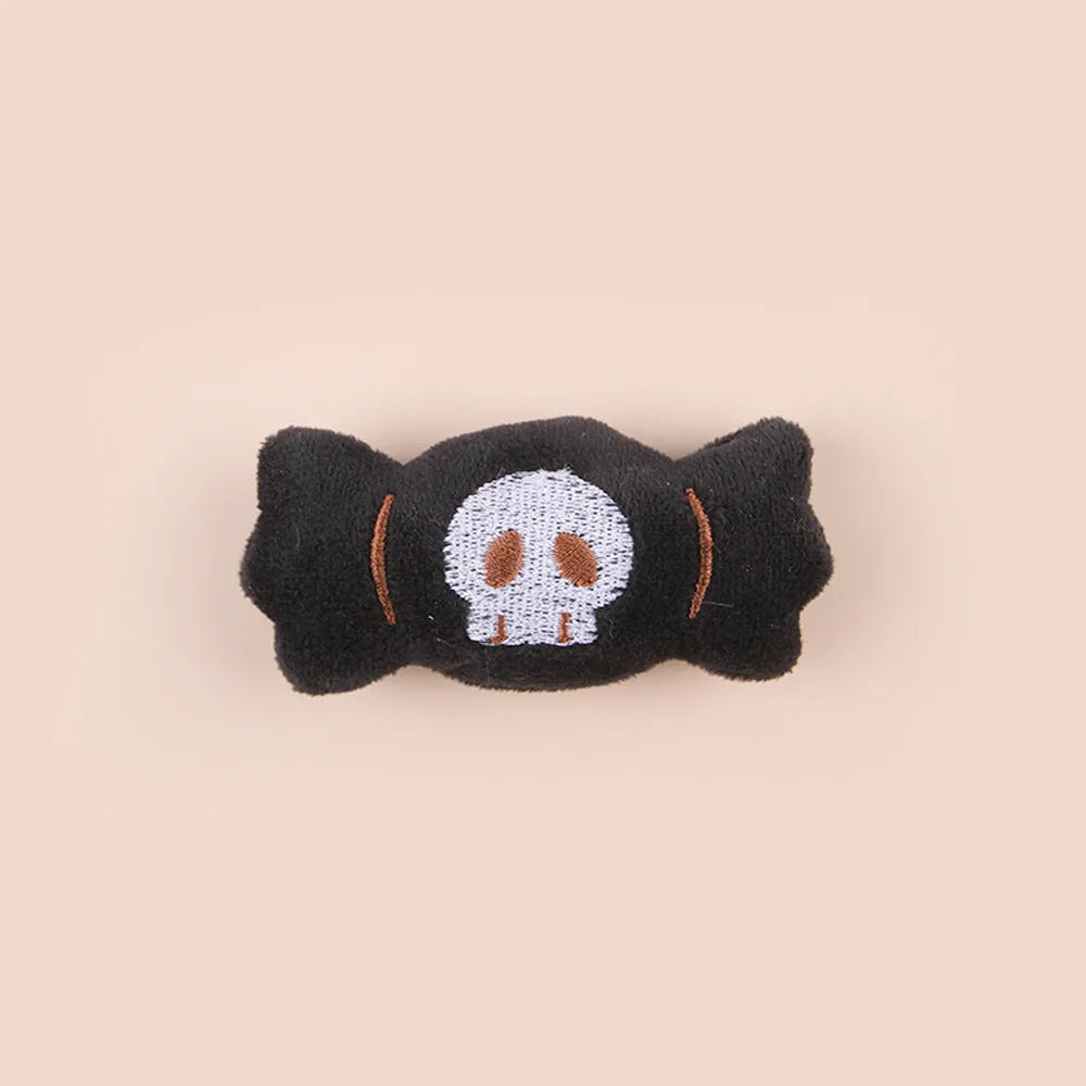 Small cat teaser toy with eyes, candy and skull plush designs on lightweight wand