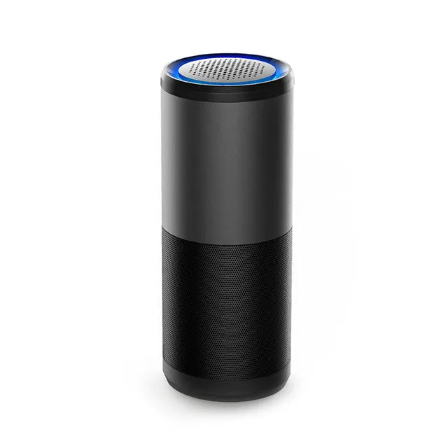 Black portable mini car air purifier with USB cable next to a car cup holder.