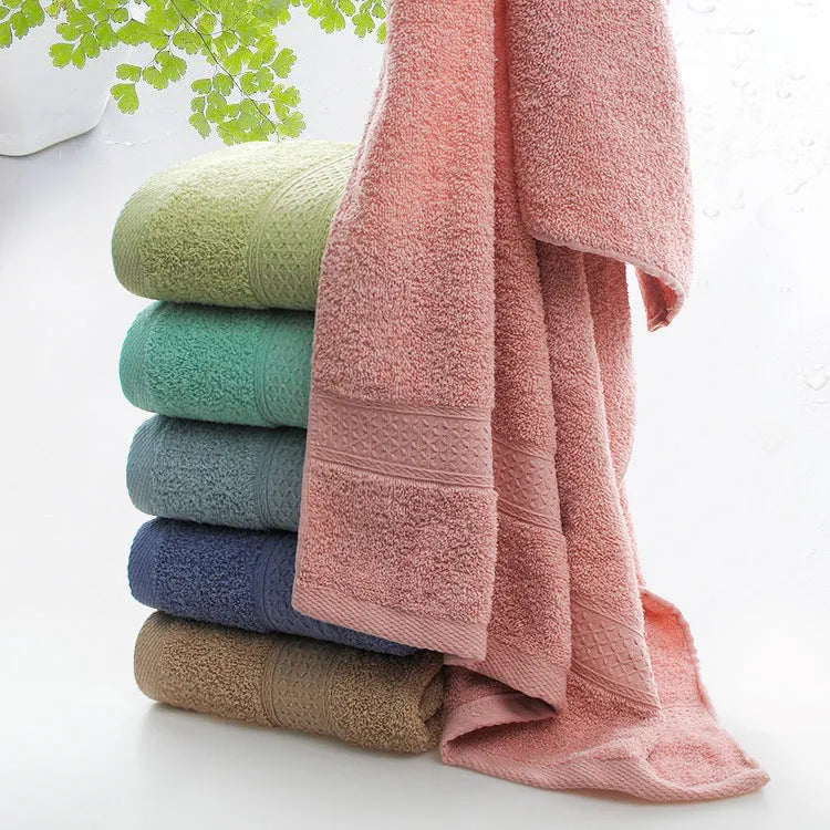 Thickened cotton blend bath towel shown in apple green colour on a bathroom rail.