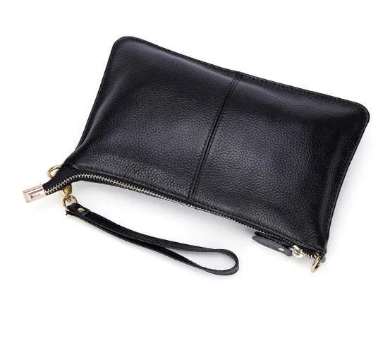 Lady's brown cowhide slant handbag with a long shoulder strap, showing front zip closure.