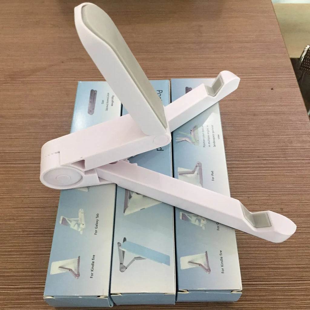 Black foldable aluminium tablet holder shown open and folded flat next to a smartphone