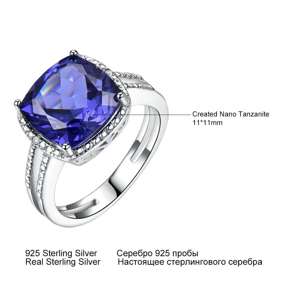 Blue tanzanite gemstone set in a sterling silver women's ring on a plain background.