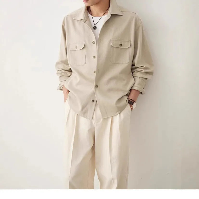 Men's light sand rice long sleeve collared shirt with collage stitch detailing on front.
