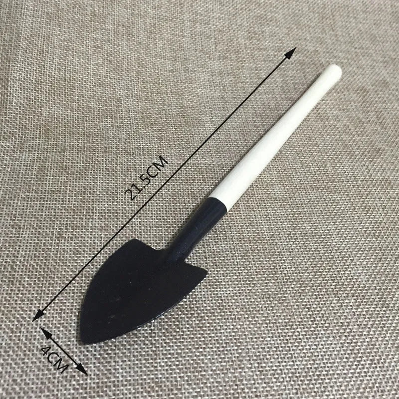 14-piece succulent gardening tool set showing mini shovels, tweezers, watering can, rake, and air blower on a table