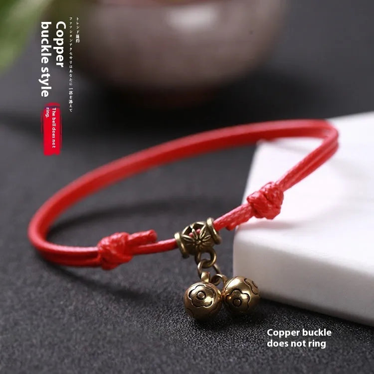 Adjustable nylon dog collar with brass bell on black rope, shown alongside red and coffee colour options.