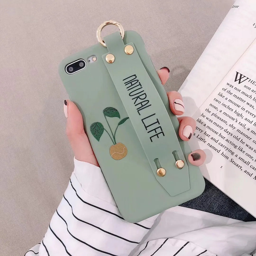 Green graffiti design iPhone wristband case with adjustable silicone strap attached to an iPhone model.