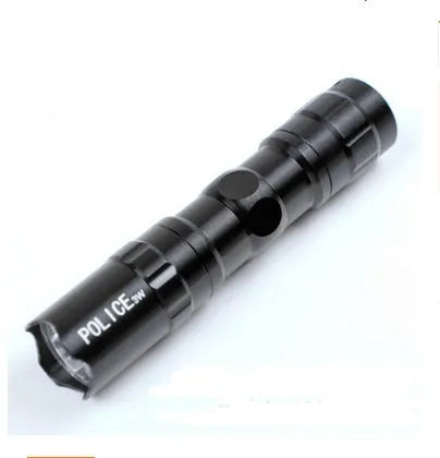 Black aluminium mini LED flashlight showing compact 9.5cm size with AA battery for scale