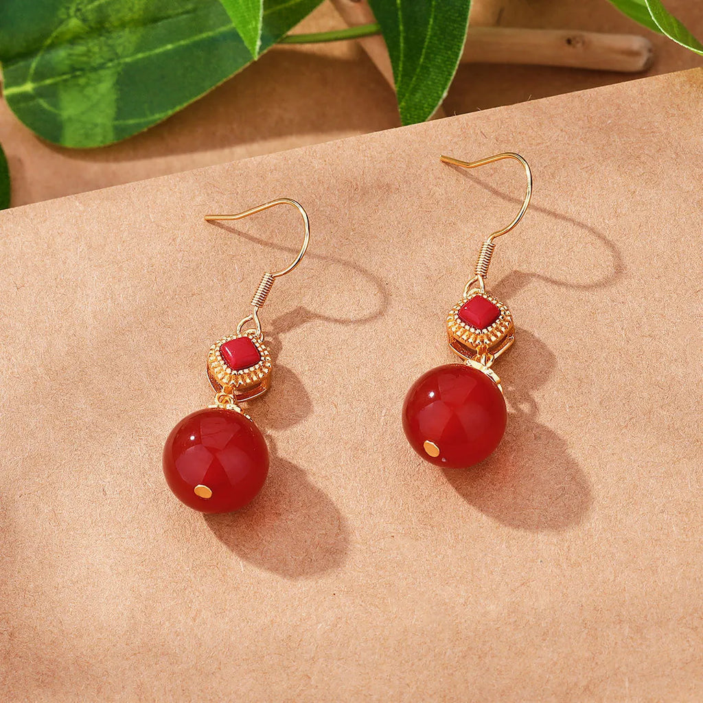 Geometric silver-plated earrings with round red agate beads and green jasper stone inlays.