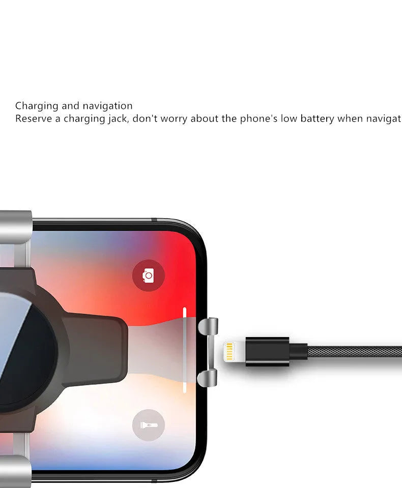 Black S4 gravity mirror car phone bracket attached to a car air conditioning vent, holding a mobile phone.