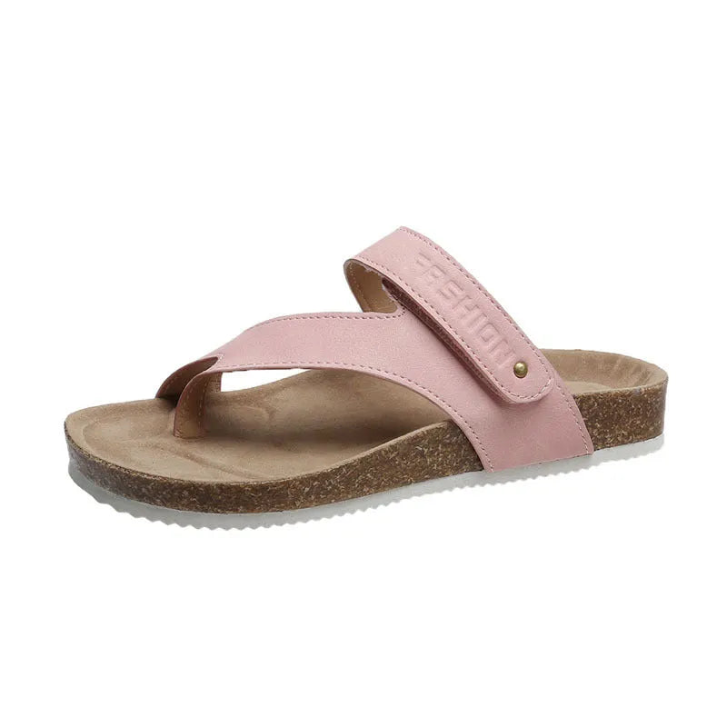 A pair of women's thick-soled flip-flops with a flat toe ring design in a solid colour.