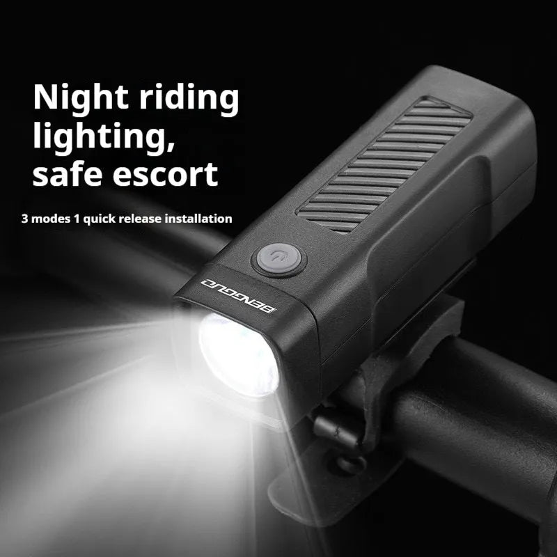 Black USB rechargeable bicycle headlight with LED and quick-release strap mount on handlebars.