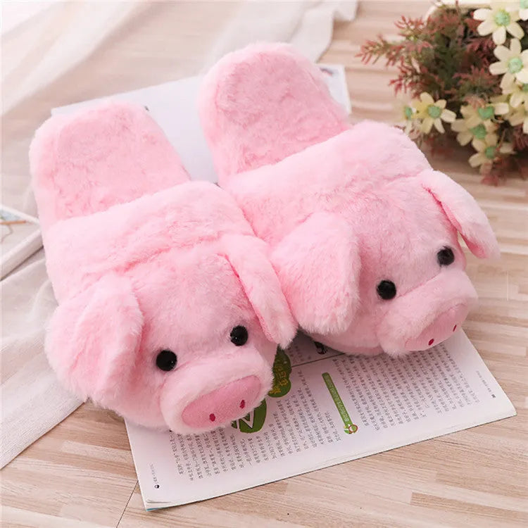 Pink plush floor slippers with a cute pig design on the upper, shown from a side view.
