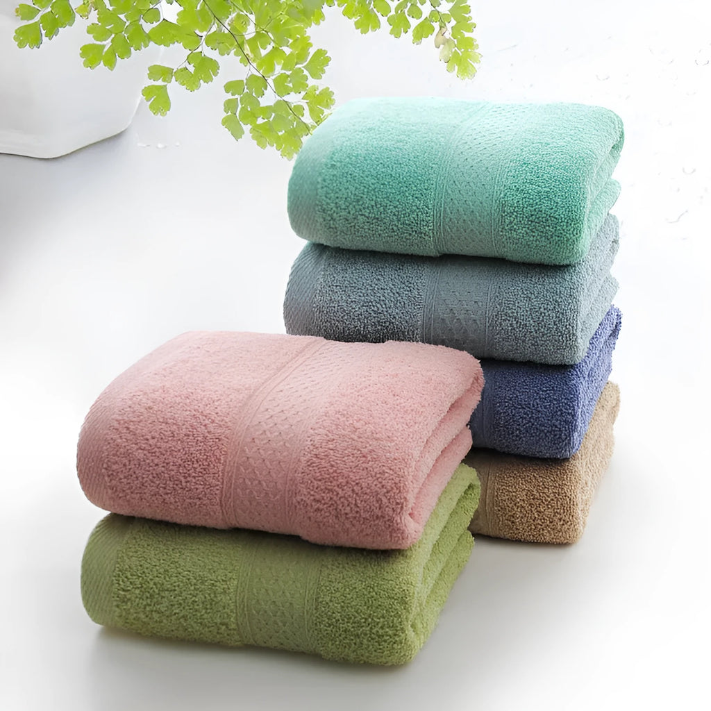 Thickened cotton blend bath towel shown in apple green colour on a bathroom rail.