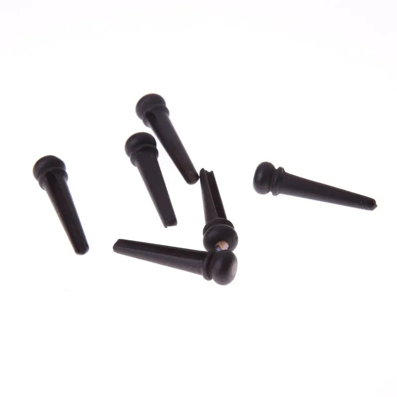 Set of six matt black ebony guitar bridge pins with 5.3mm diameter for folk acoustic guitars.