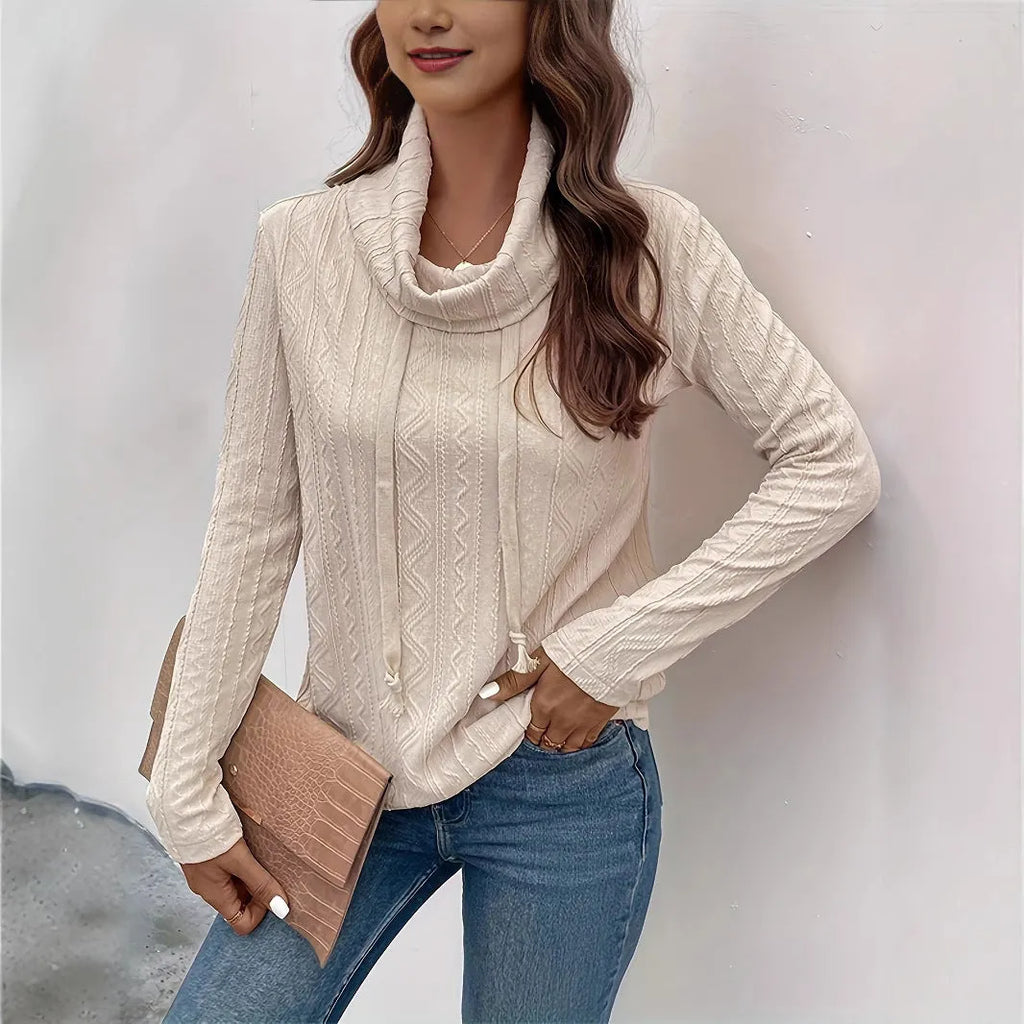 Apricot coloured long sleeve hooded pullover sweater with a drawstring.