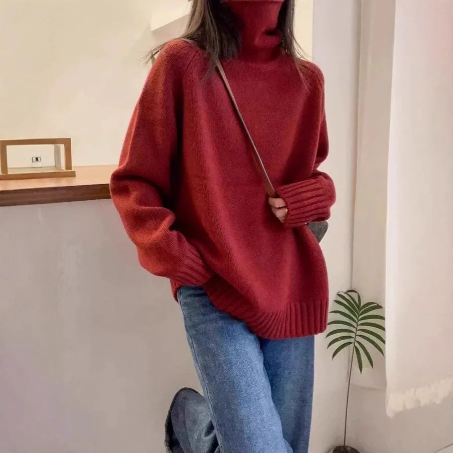 Women's loose grey turtleneck sweater with a thick, textured curling pile collar.