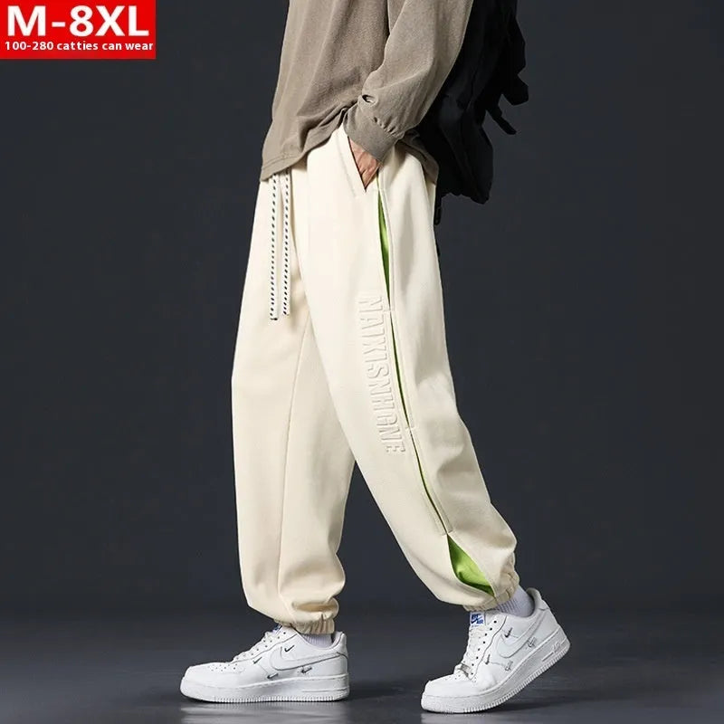 Men's loose-fit ankle banded cotton trousers with stitching detailing and skinny leg opening in grey green colour