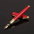 Red and black metal fountain pen with a 0.5mm Yijin nib on a writing surface.