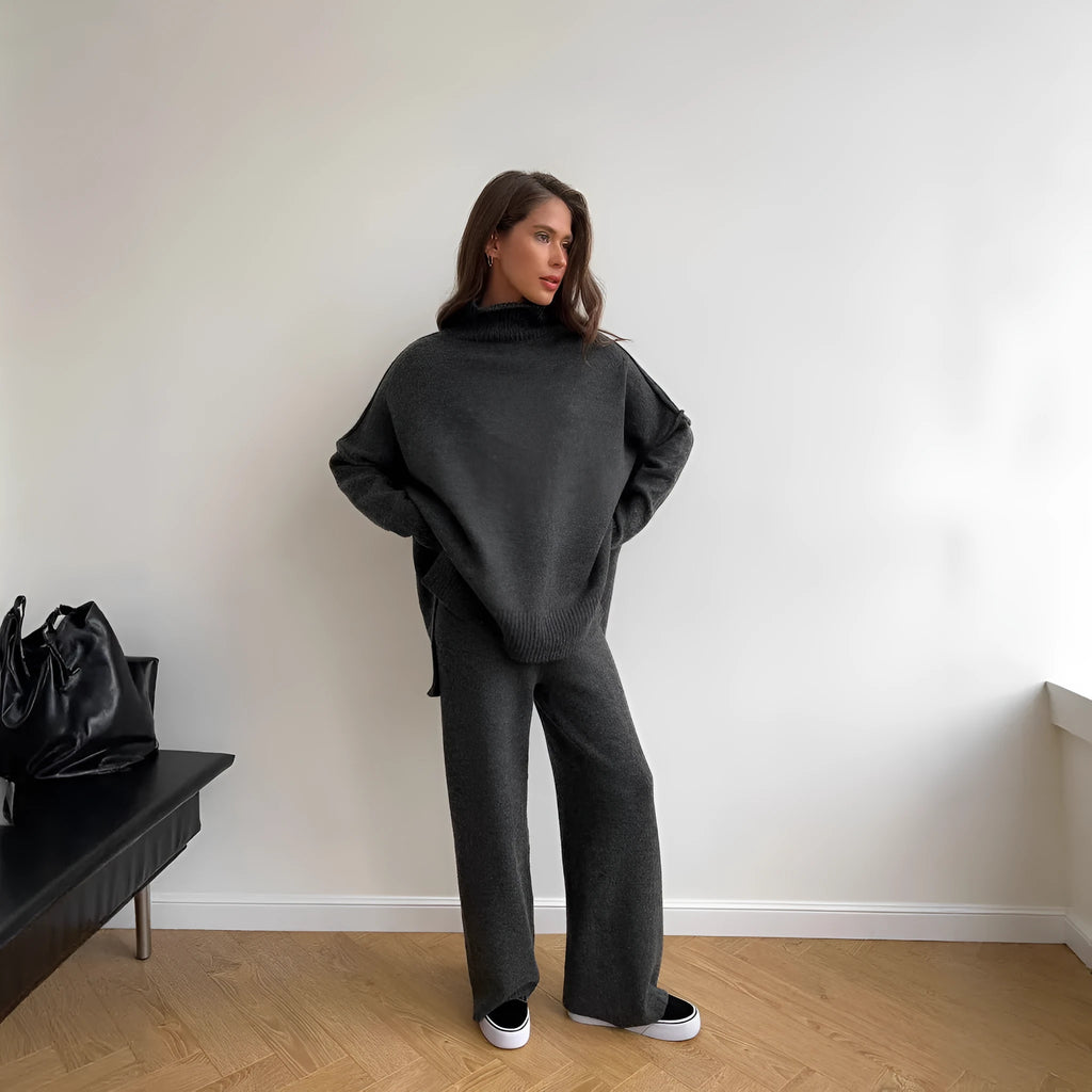 Women's dark grey acrylic jumper suit with side slits on the top and matching trousers.