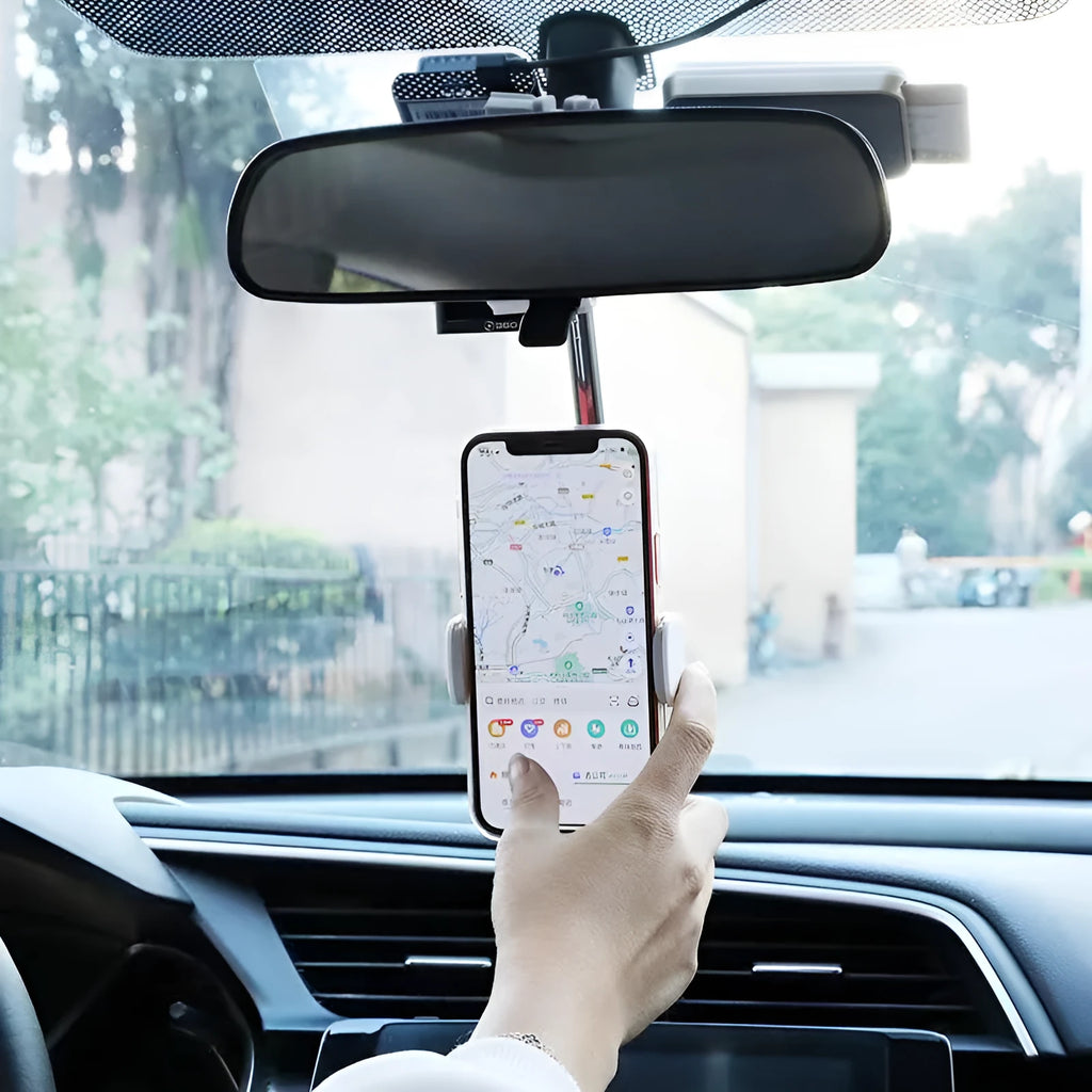 Black mobile phone bracket attached to car rearview mirror holding smartphone