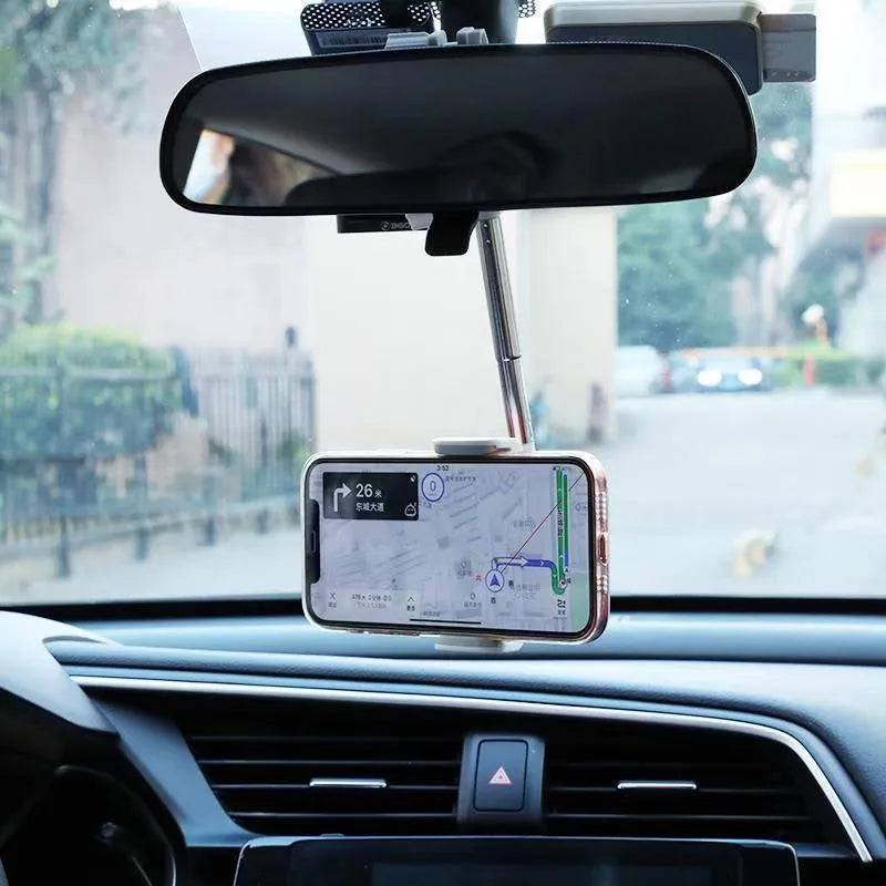 Black mobile phone bracket attached to car rearview mirror holding smartphone