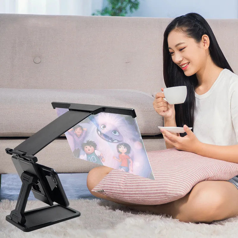 Black L20 split mobile phone screen magnifier with separate bracket on a table.
