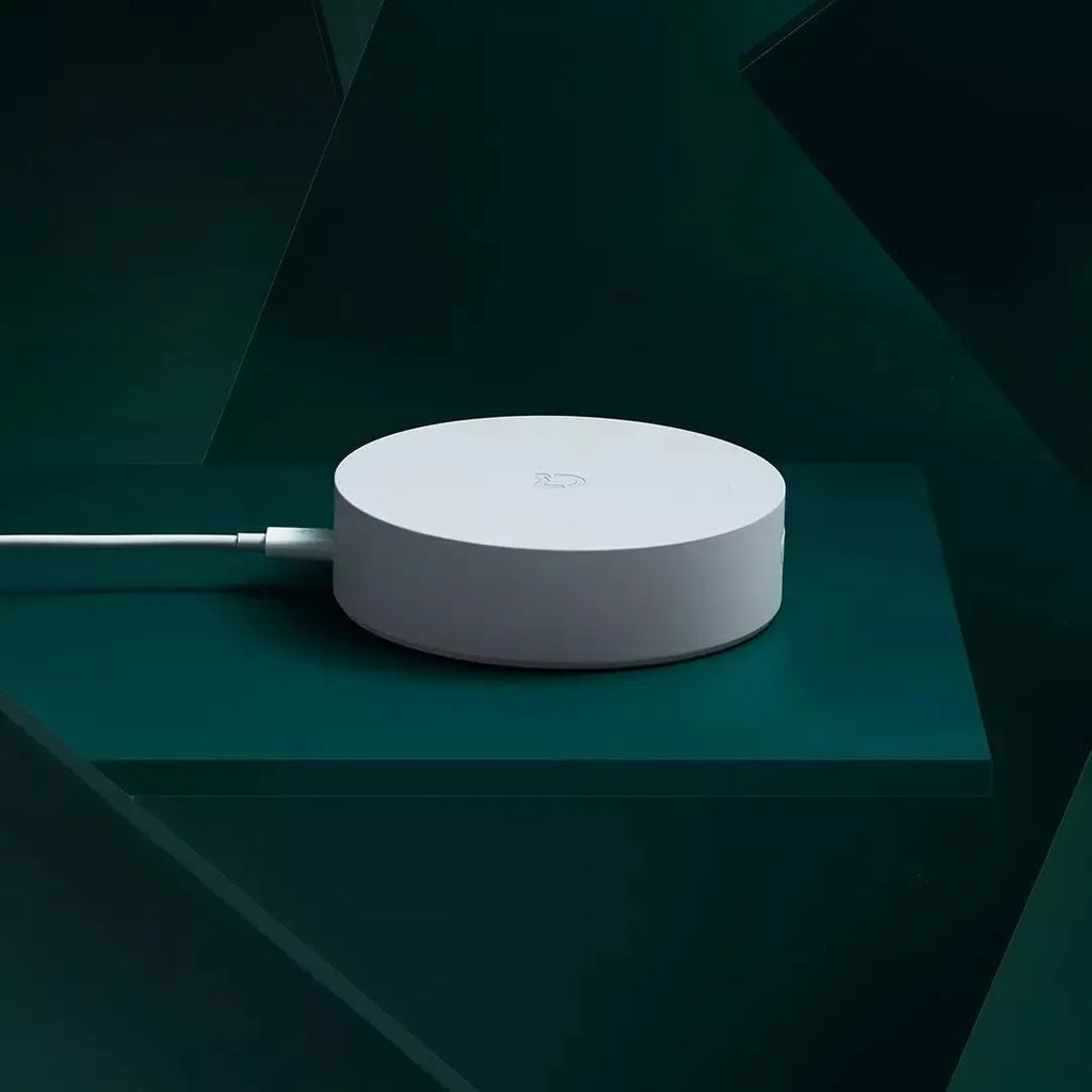 White circular Xiaomijia smart home gateway with UK plug, 90mm diameter wireless wall switch