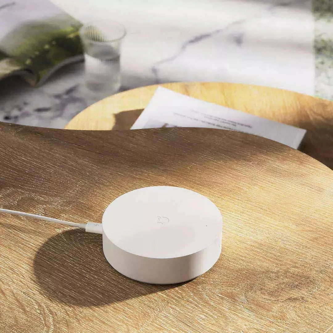 White circular Xiaomijia smart home gateway with UK plug, 90mm diameter wireless wall switch