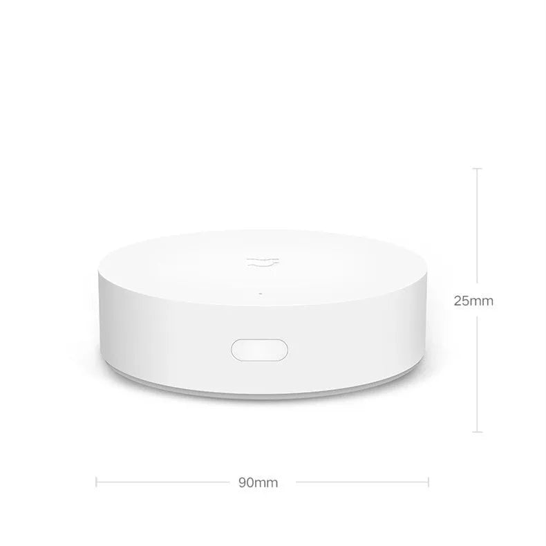 White circular Xiaomijia smart home gateway with UK plug, 90mm diameter wireless wall switch