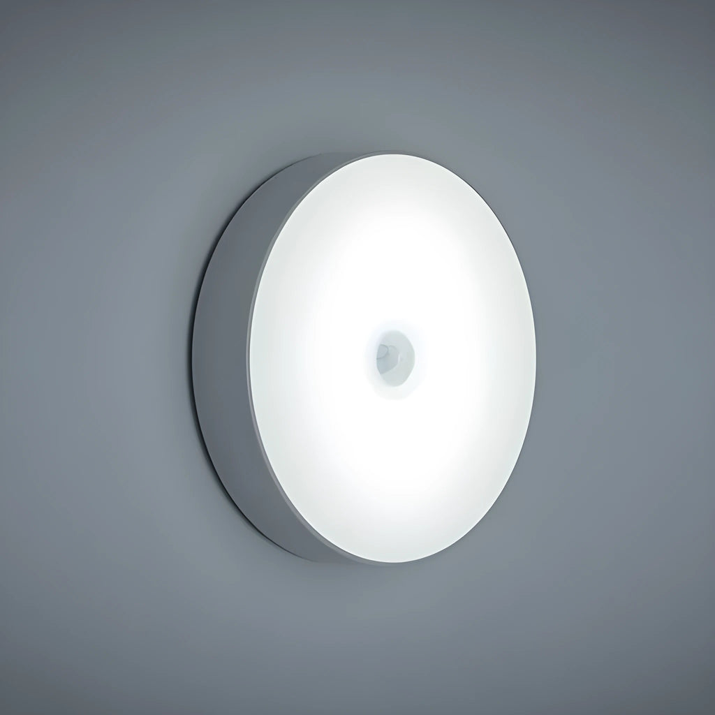 USB rechargeable motion sensing LED night light in beige or white with compact circular design