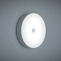 USB rechargeable motion sensing LED night light in beige or white with compact circular design