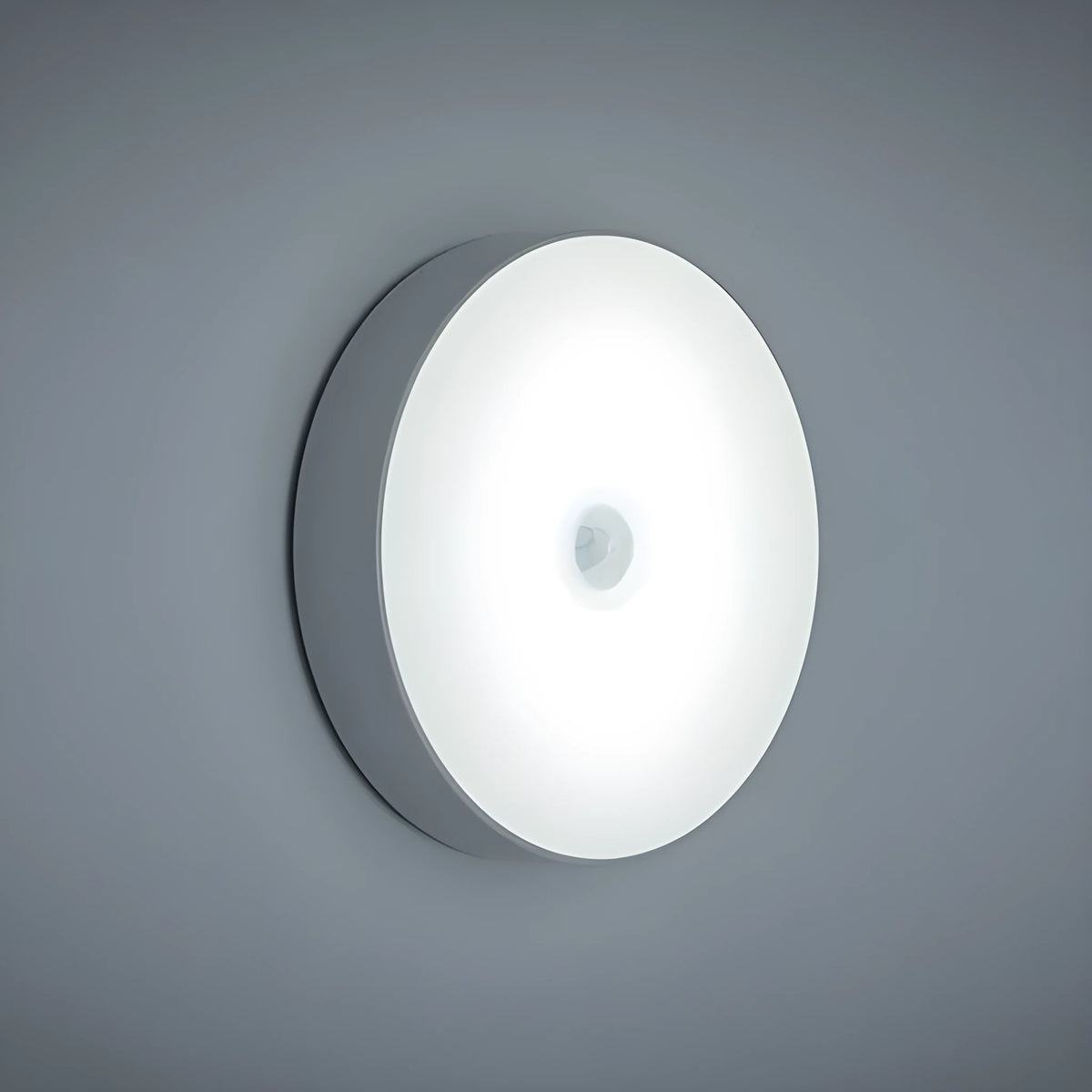 USB rechargeable motion sensing LED night light in beige or white with compact circular design