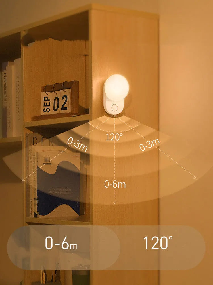 White Baseus rechargeable night light with motion sensor on a bedside table.