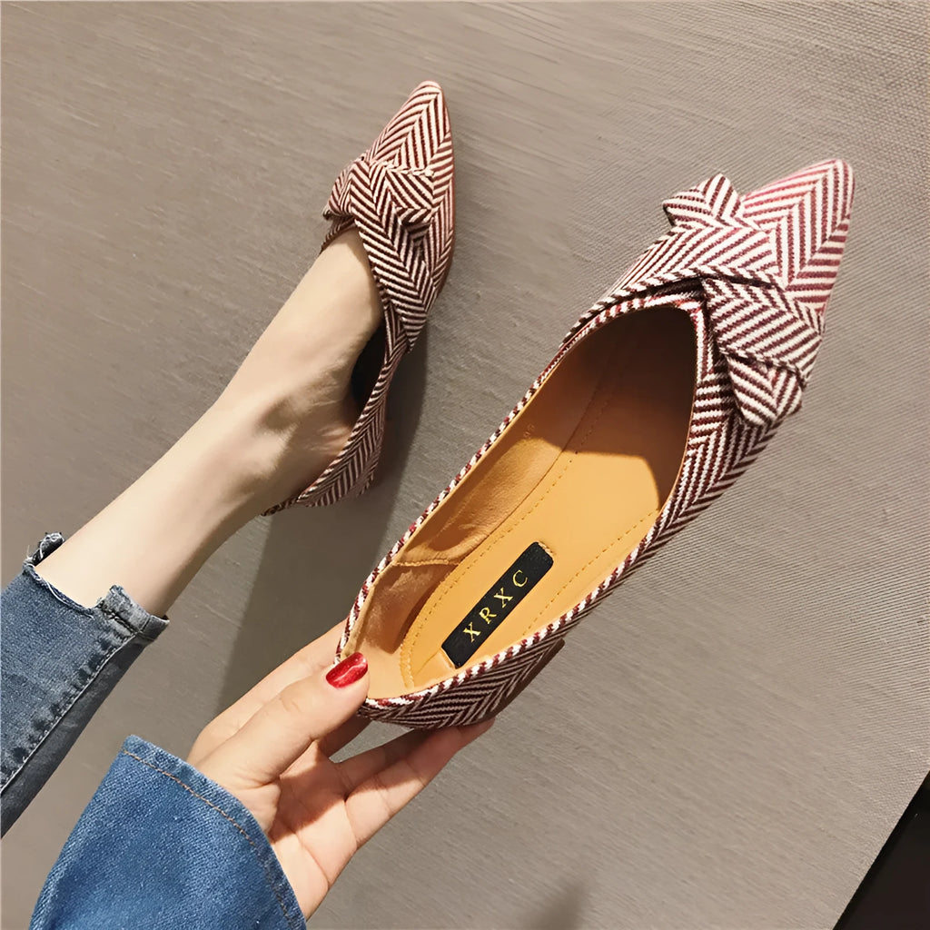 Red women's pointed toe shallow mouth casual shoes with flat heel on a white background.