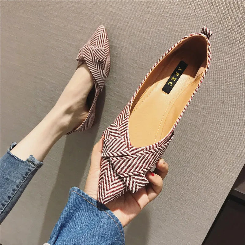 Red women's pointed toe shallow mouth casual shoes with flat heel on a white background.