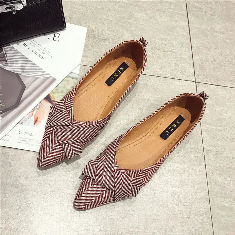 Red women's pointed toe shallow mouth casual shoes with flat heel on a white background.