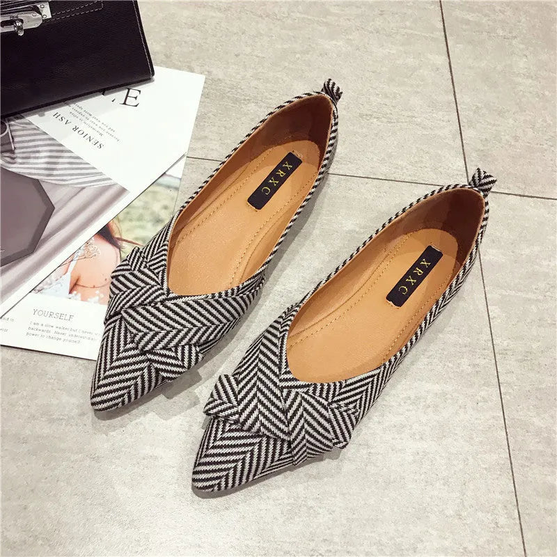 Red women's pointed toe shallow mouth casual shoes with flat heel on a white background.