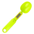 Black digital measuring spoon scale showing weight on display, with spoon bowl for holding materials.