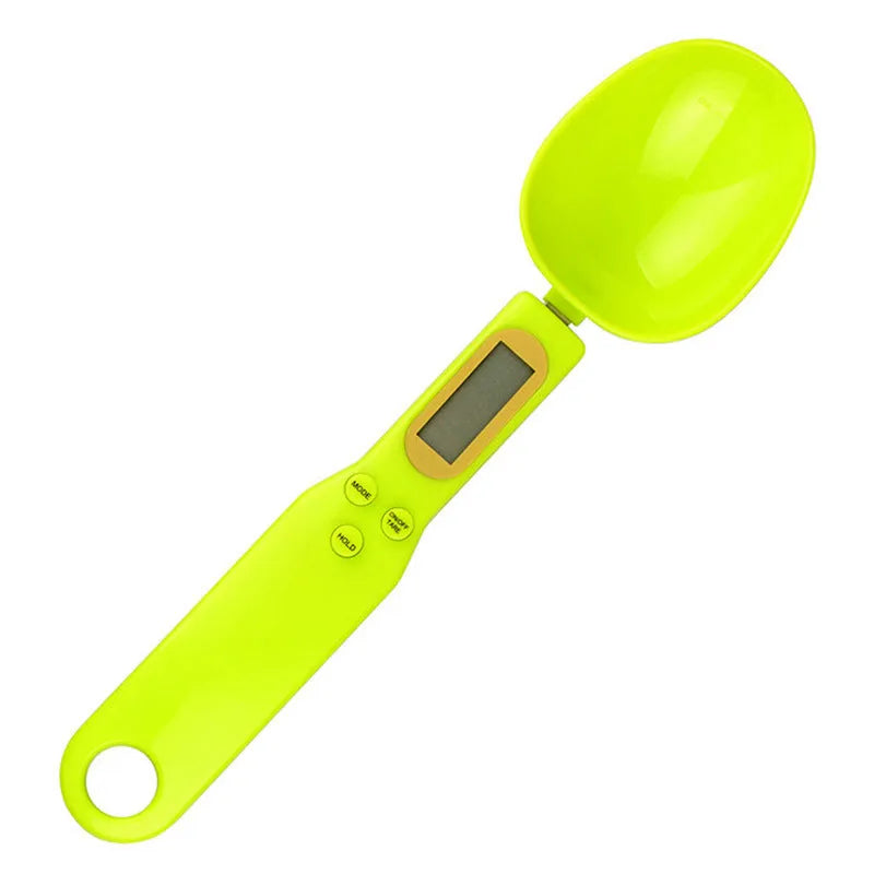 Black digital measuring spoon scale showing weight on display, with spoon bowl for holding materials.