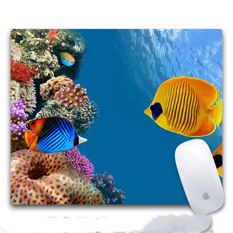 Custom printed rectangular mouse pad with cloth surface and rubber base on a desk.